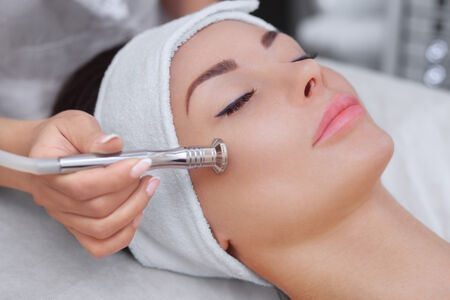 Woman getting microdermabrasion treatment